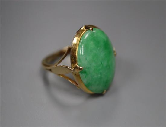 A yellow metal and oval cabochon jadeite set ring, size J, gross 4.6 grams,